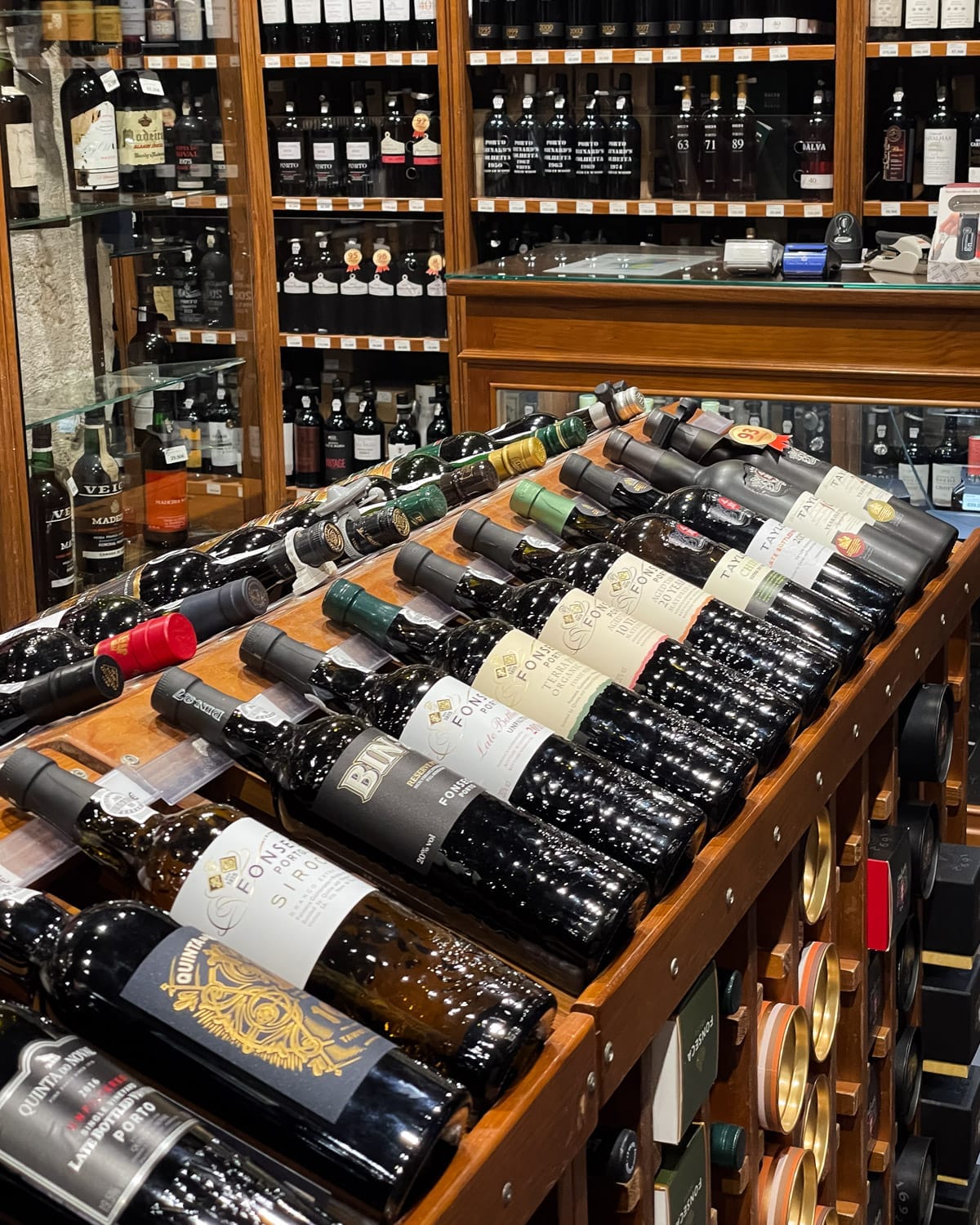 Wine shop in Lisbon with shelves of vintage port and neatly arranged wine bottles.