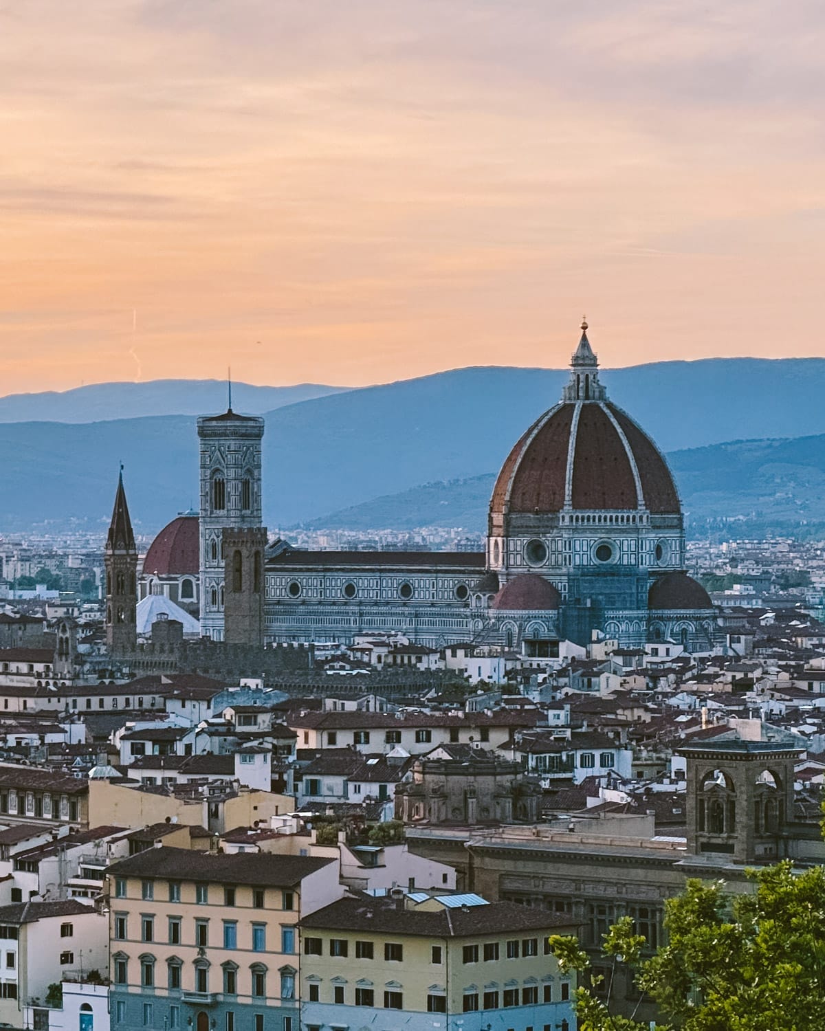 Florence’s Duomo, Santa Maria del Fiore, stands tall at sunset with its iconic dome above the city.