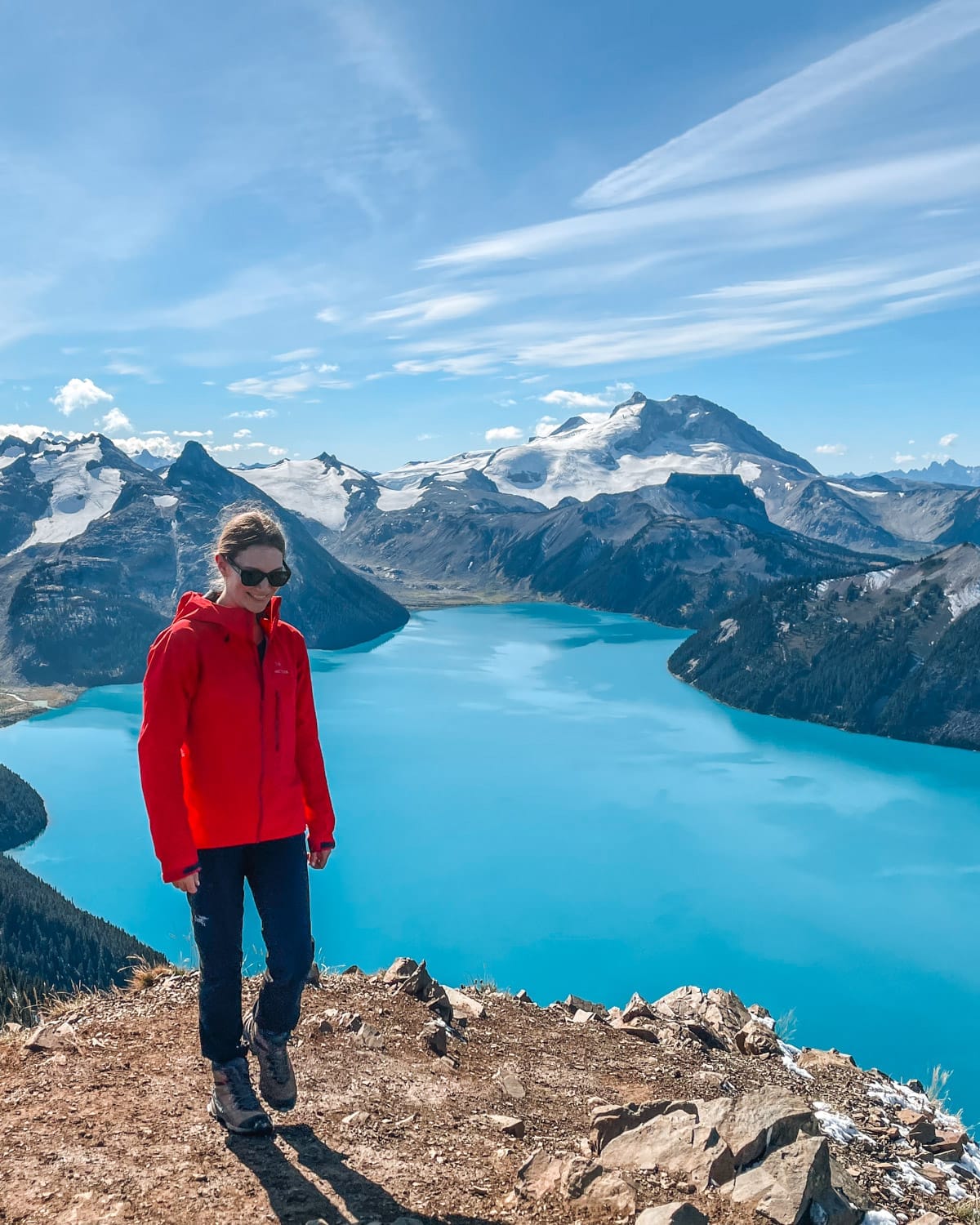 Cec stands on Panorama Ridge overlooking Garibaldi Lake’s vibrant blue waters and snow-capped mountains.