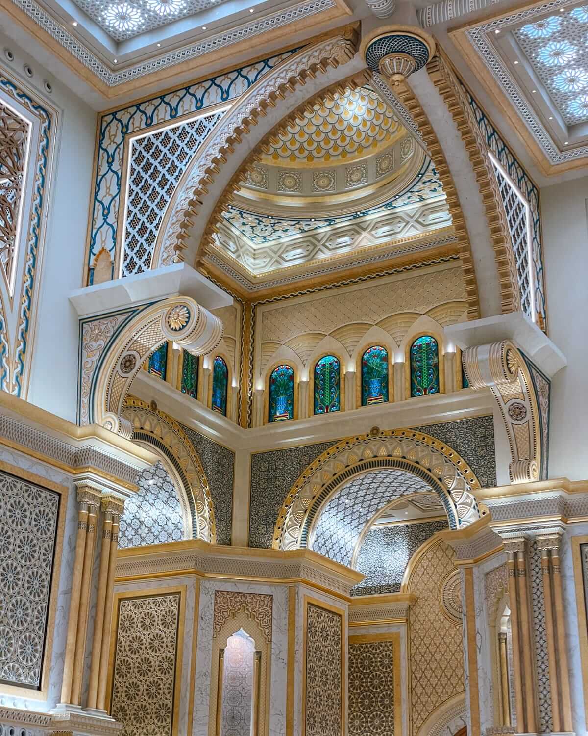 Elaborate arches, intricate mosaic patterns, and stained glass windows inside the ornate Qasr Al Watan palace in Abu Dhabi.