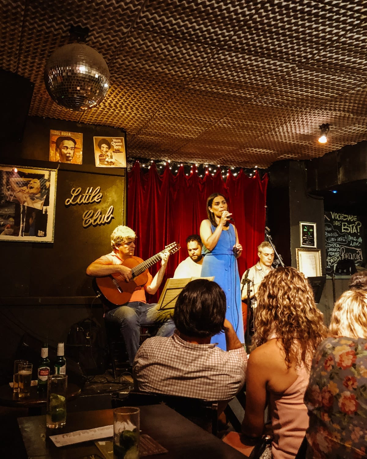 Live Bossa Nova performance at Little Club in Rio de Janeiro with a singer in blue and a band playing to an intimate crowd.