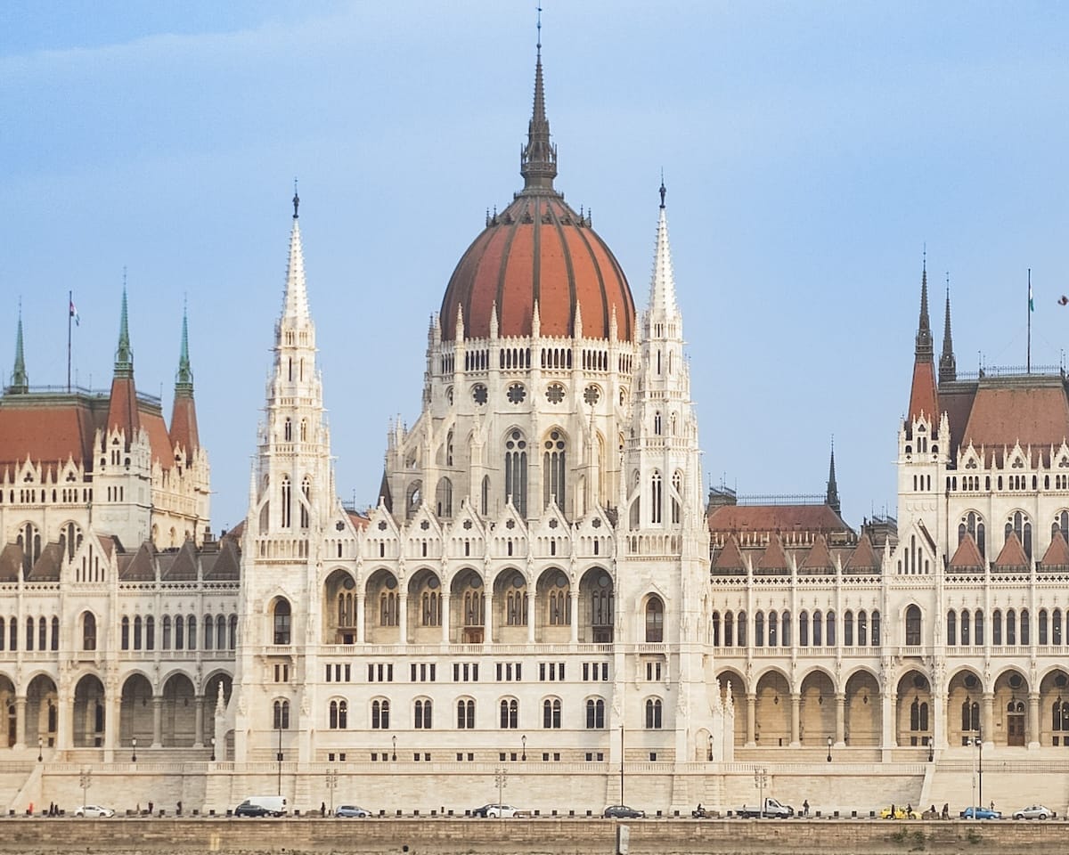 Front view of the grand Hungarian Parliament Building in Budapest, showcasing its gothic spires and central dome.