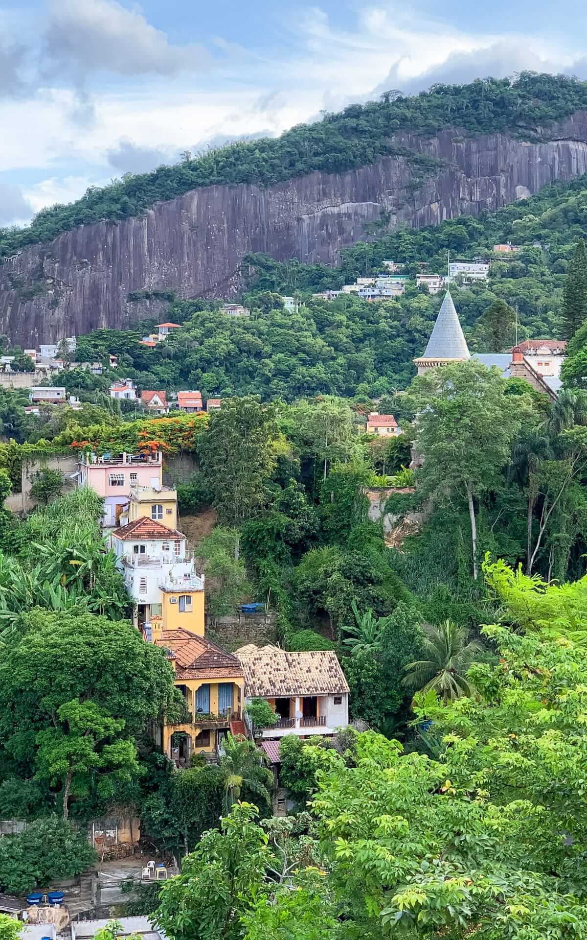 View of colourful hillside homes nestled in the jungle from Santa Teresa. 