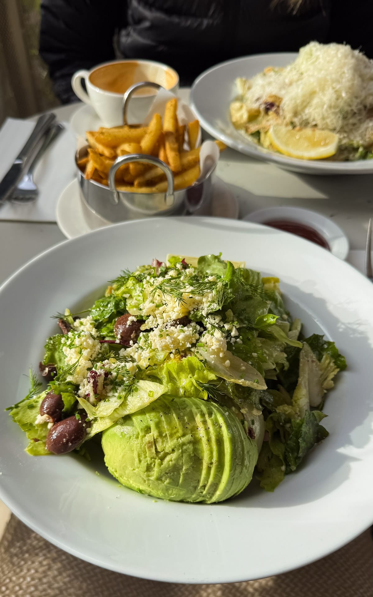 Fresh avocado salad and fries at Oli Cafe, a popular neighbourhood bistro in Palermo.