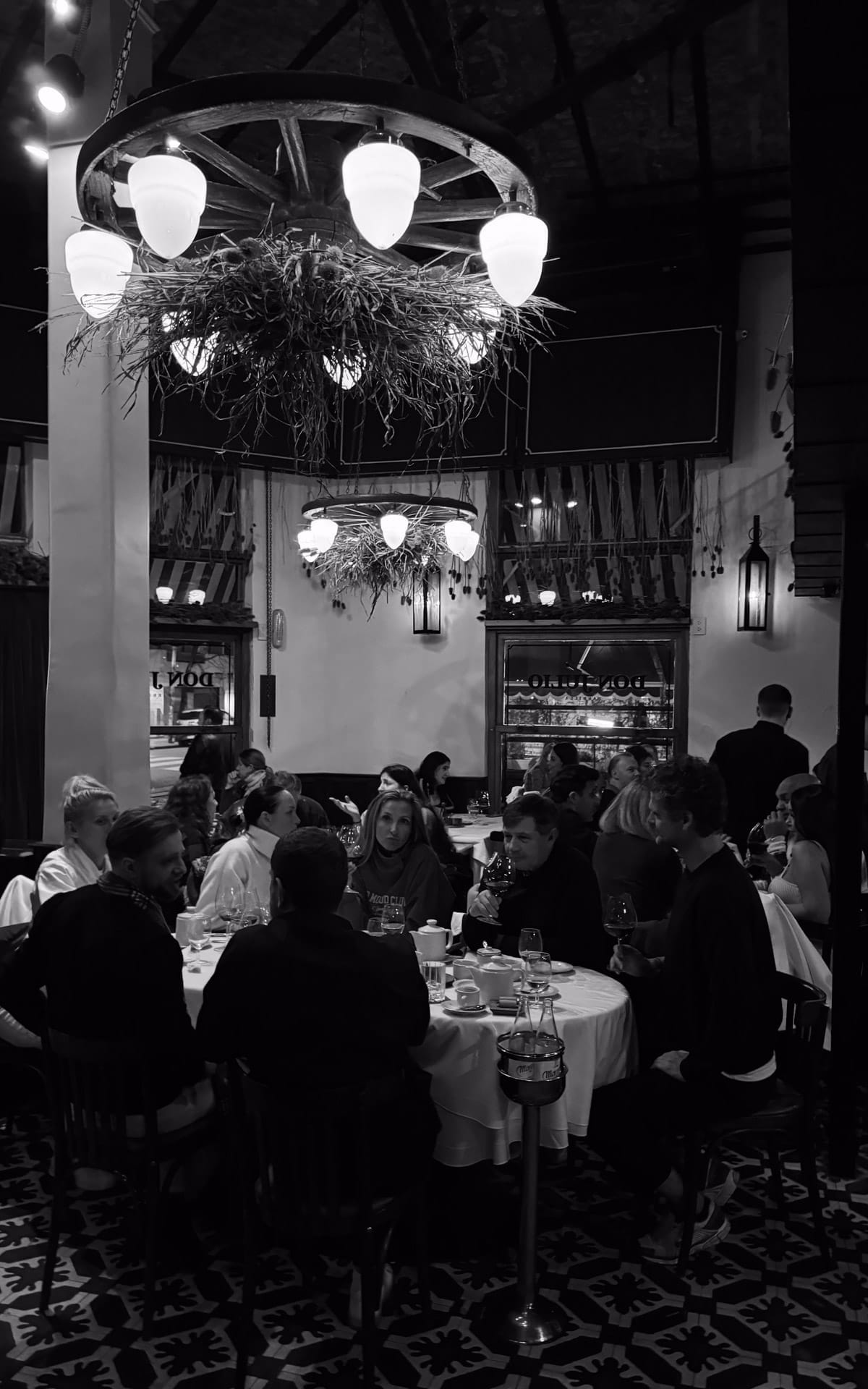 Don Julio's inside dining room with chandeliers and groups enjoying dinner.