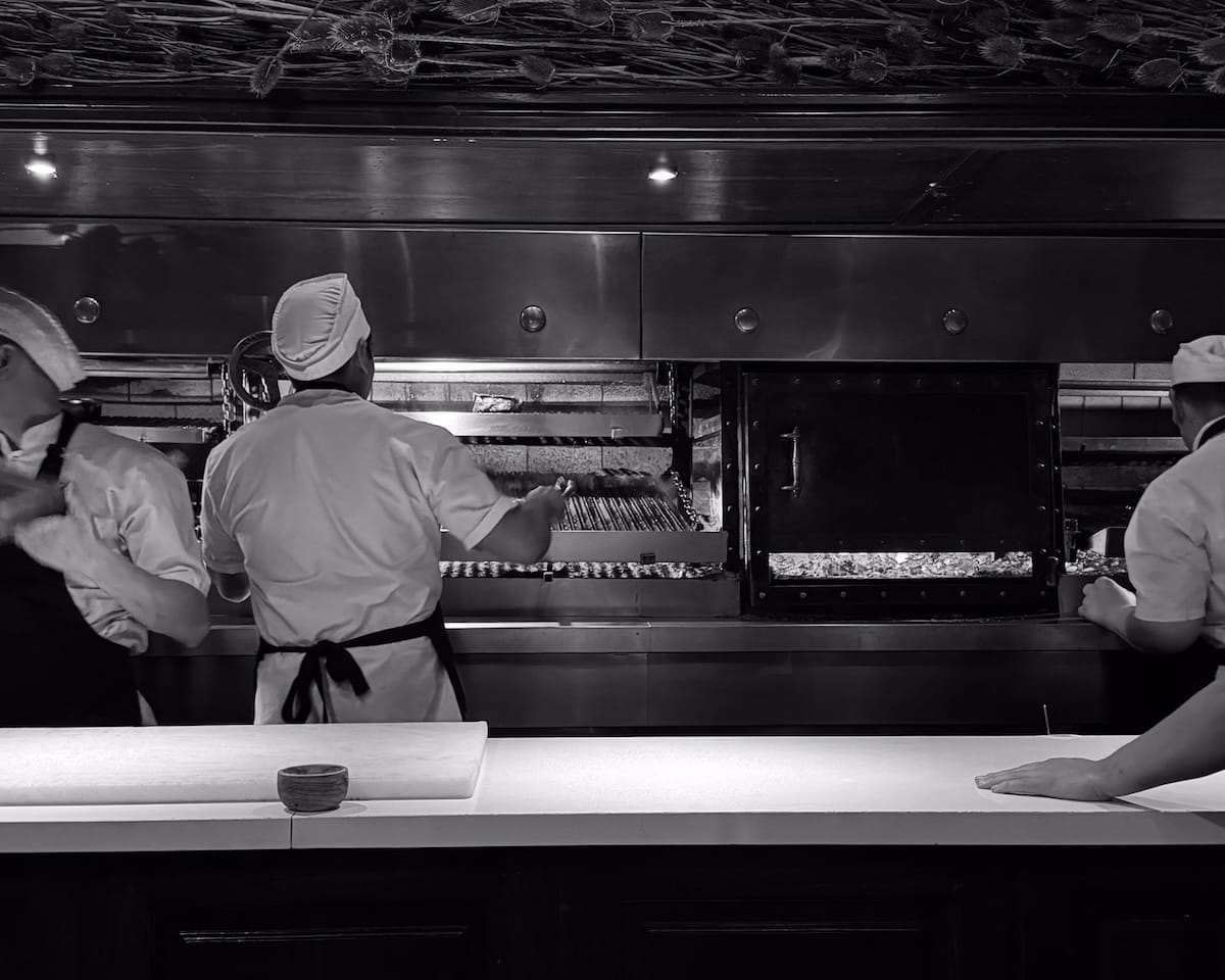 Chefs grilling meat at Don Julio steakhouse.