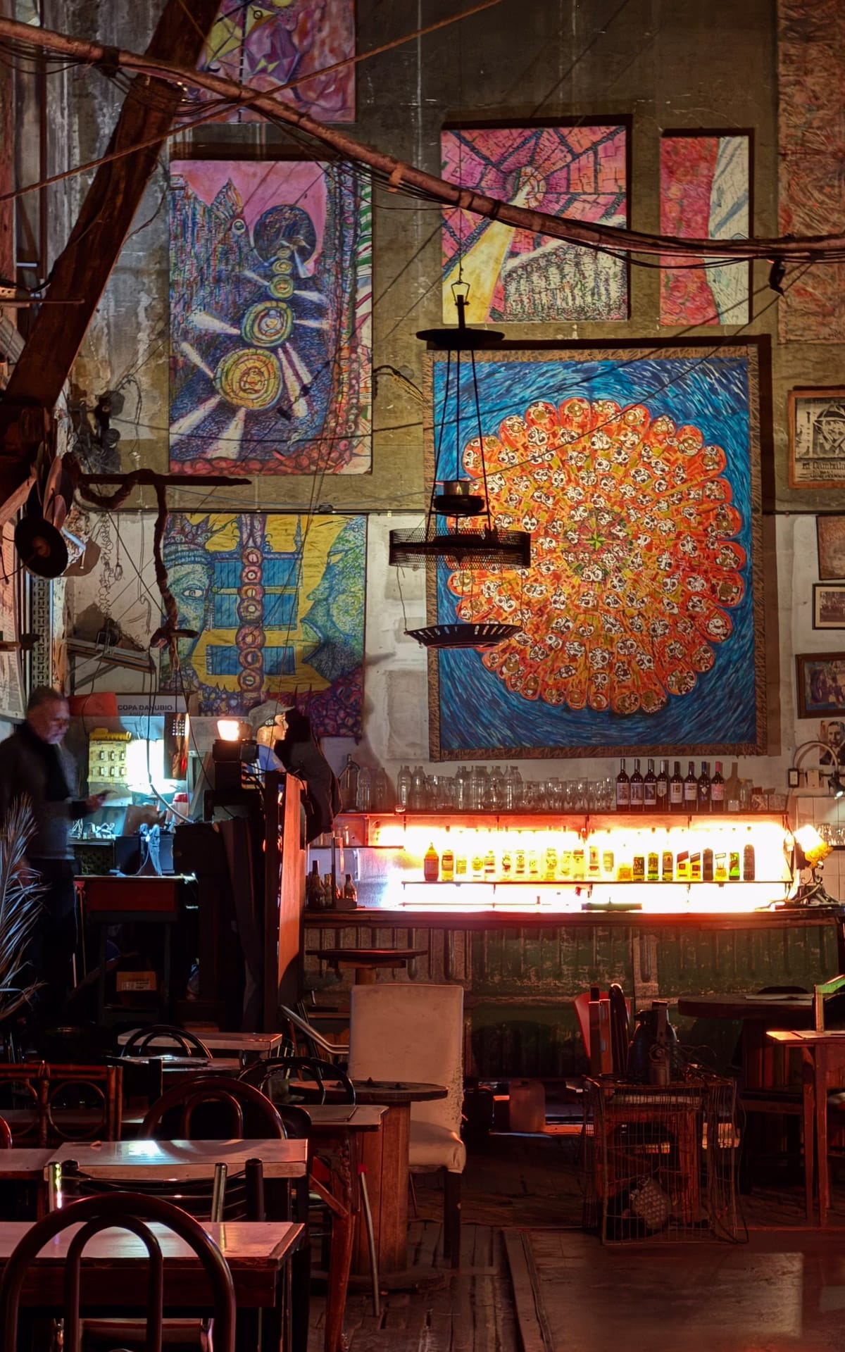 La Catedral, an eclectic tango club with colourful abstract murals, dim lighting, and vintage furniture.