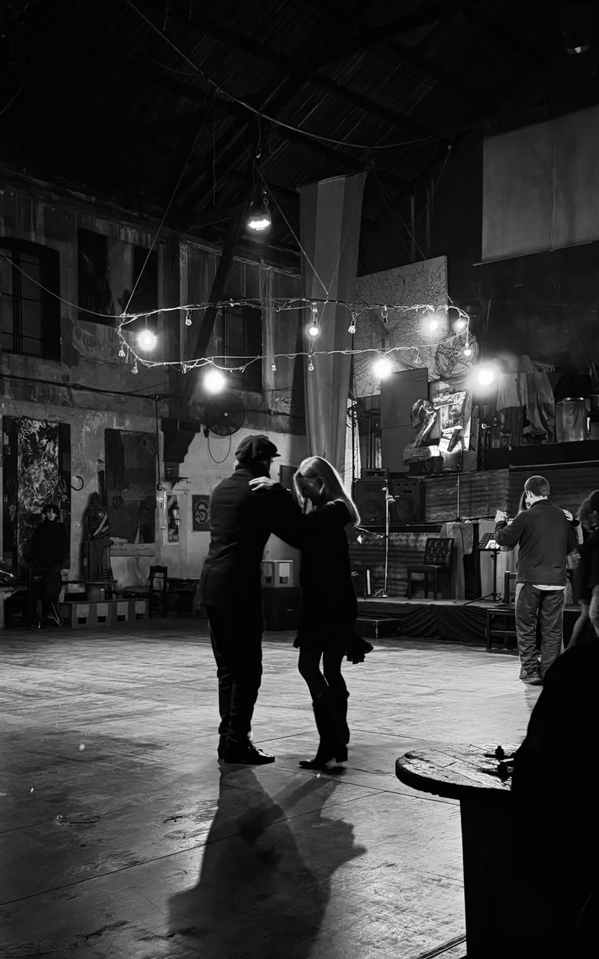 Black and white photo of Cec dancing with a tango partner in La Catedral Club. 