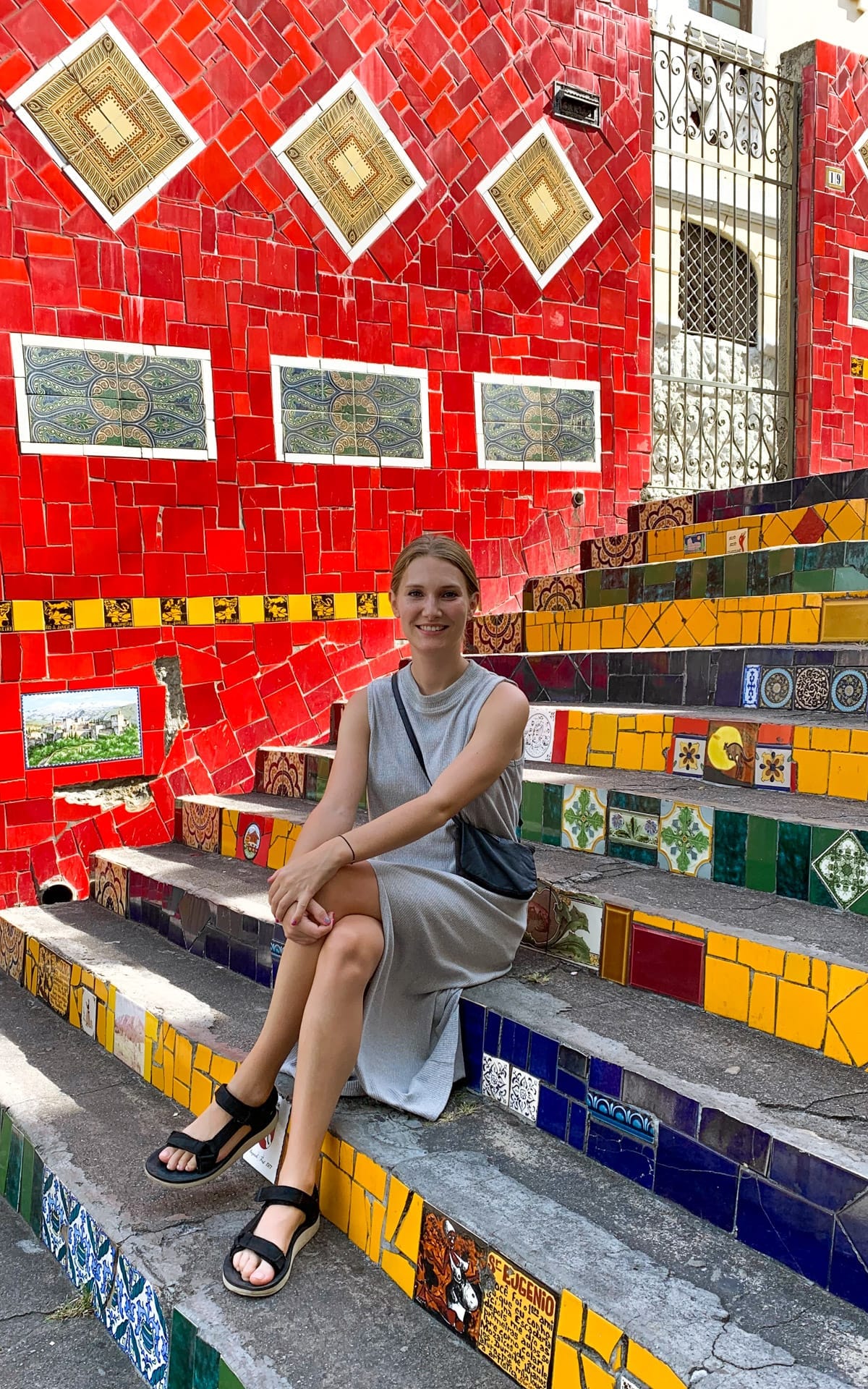 Cec sitting on the vibrant mosaic-tiled Selarón steps, one of the best things to see in Rio de Janeiro.