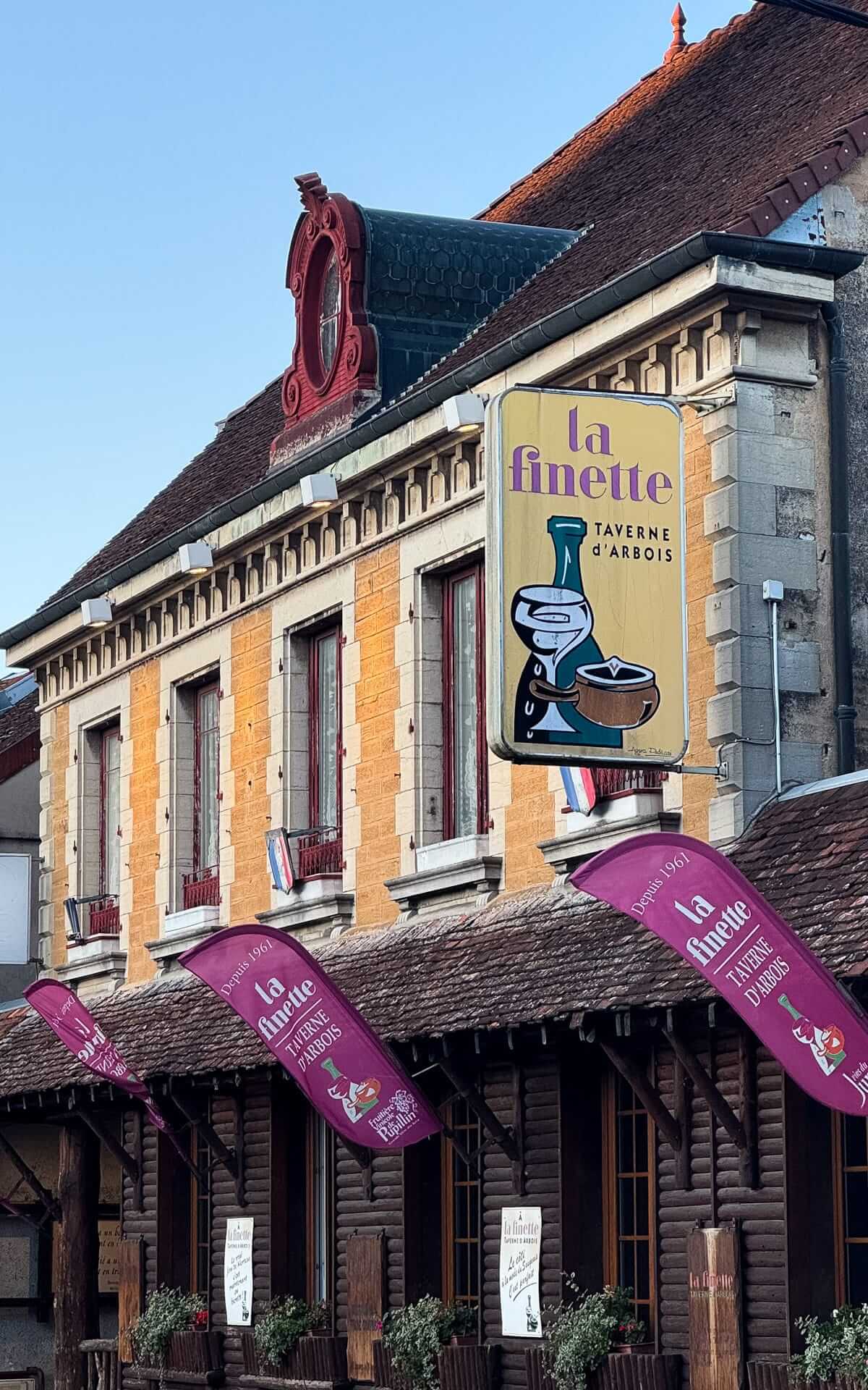 Exterior of La Finette in Arbois with traditional signage and timber details.