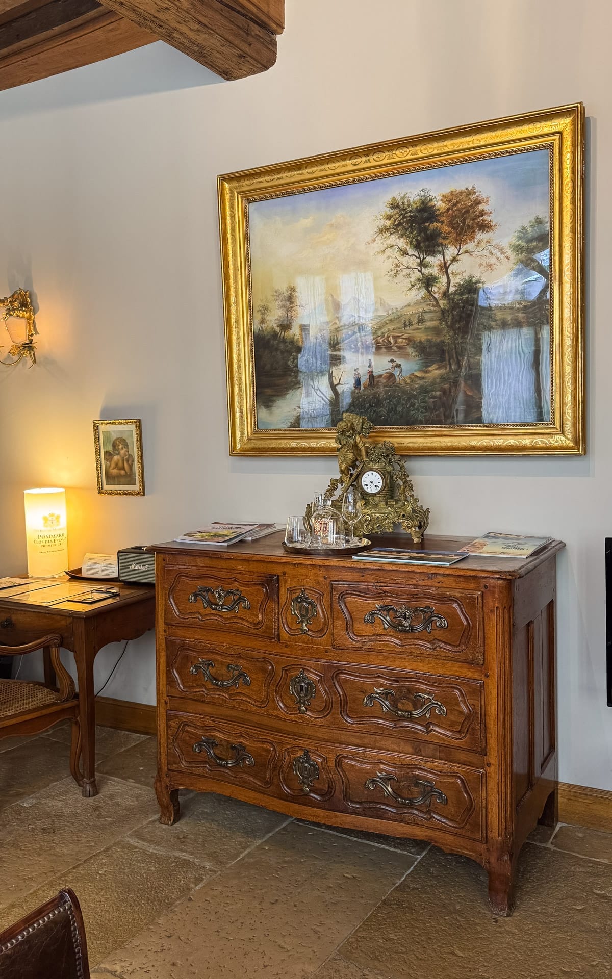 Antique wooden dresser and artwork inside Le Clos Sainte Marguerite in Beaune.
