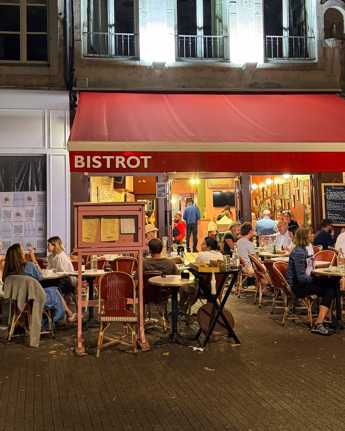 Evening street scene in Beaune with outdoor dining at a Bistrot Rosette.