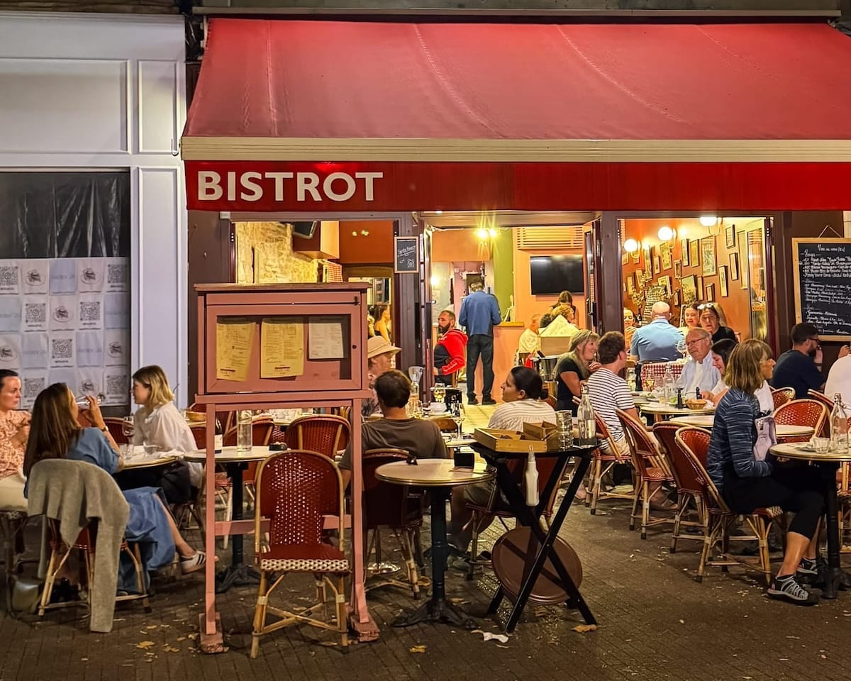 Outdoor seating at a Rosette Bistrot in Beaune during evening service.