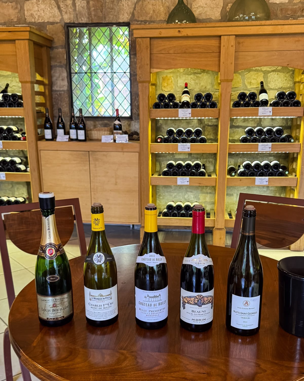 Selection of Burgundy wine bottles displayed for tasting at La Grande Cave de Vougeot.