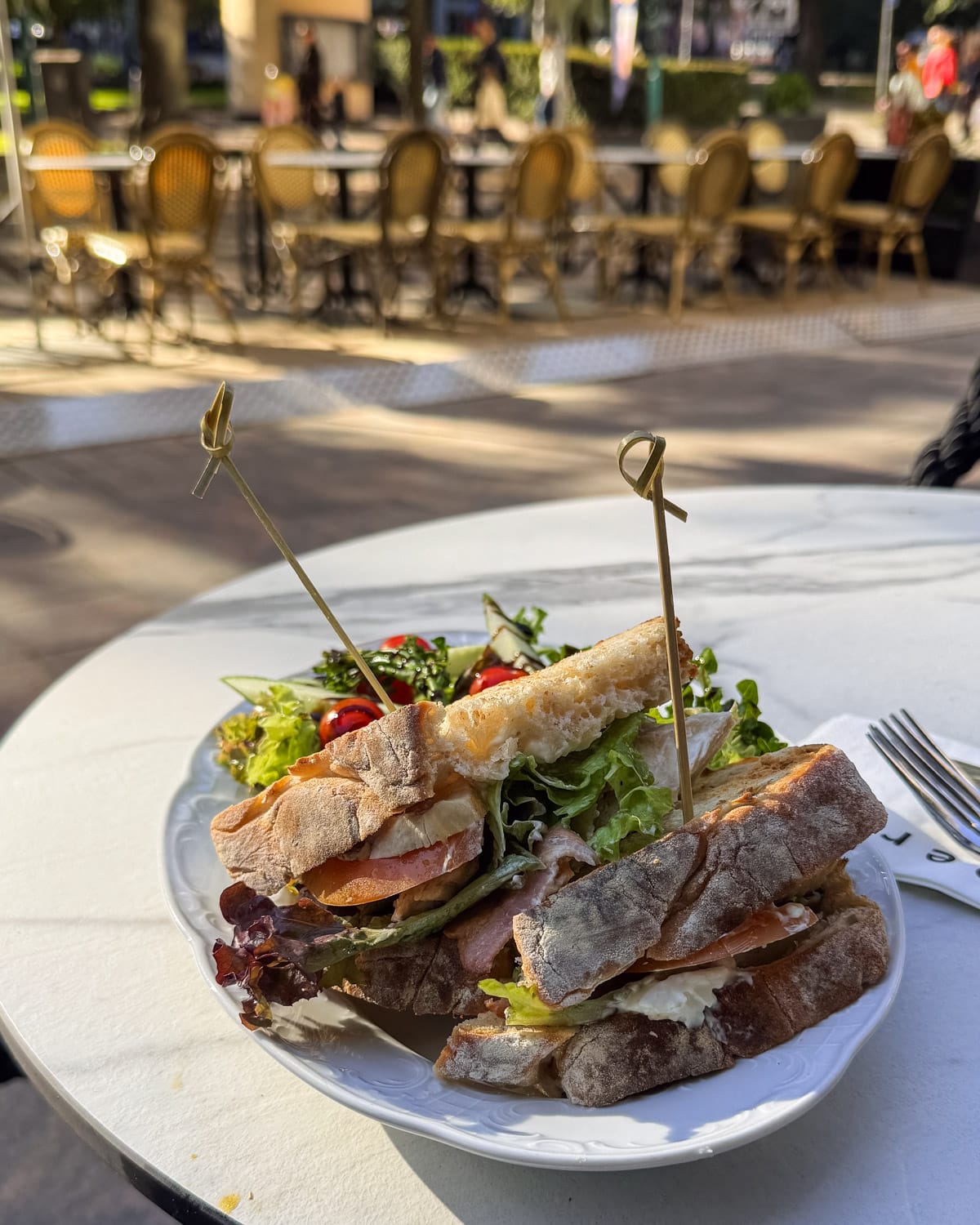 Sandwich and salad served on the terrace of Cafe Strindberg overlooking Esplanadi Park.