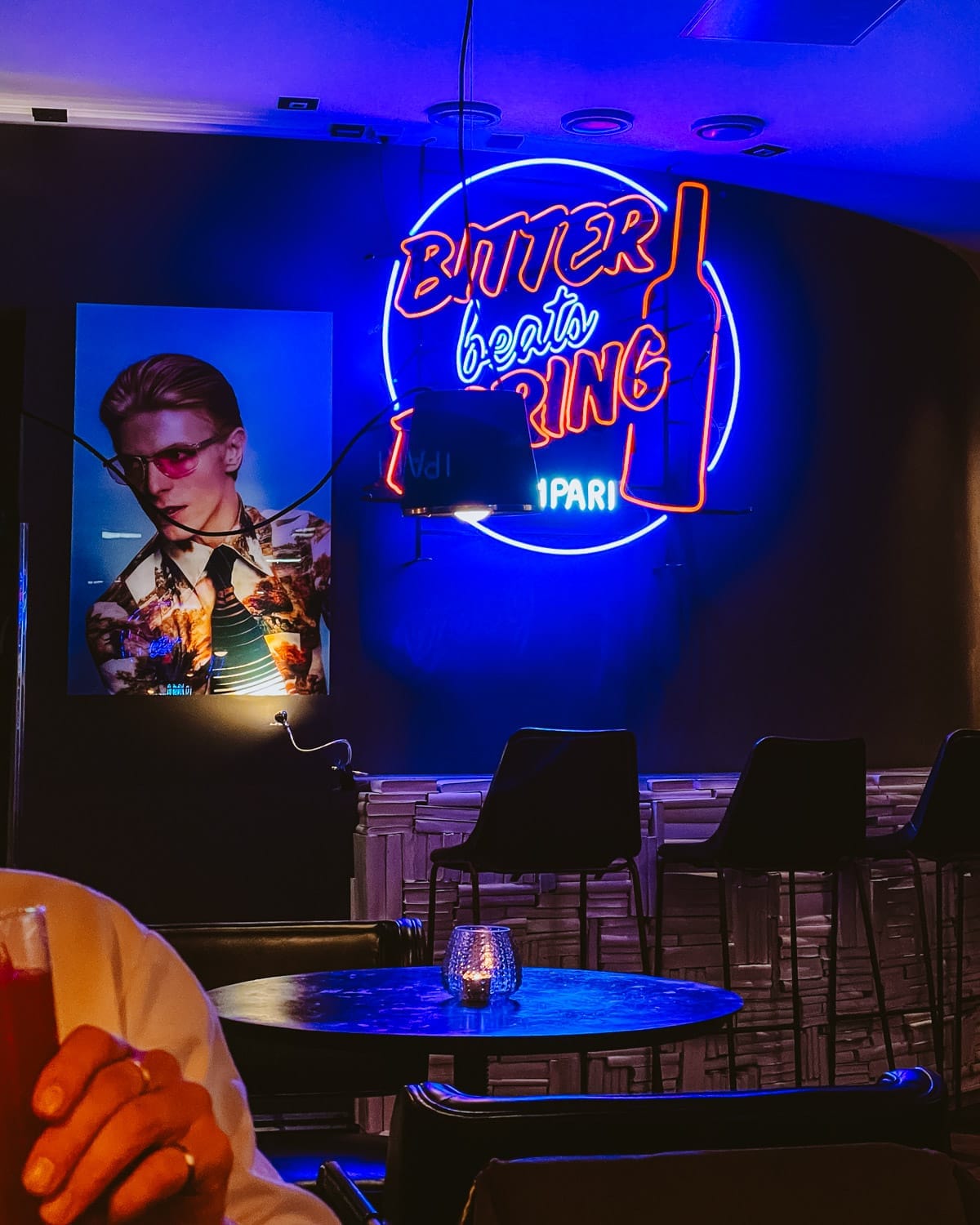 Neon “Bitter Beats Boring” sign glowing inside Bar Runar.