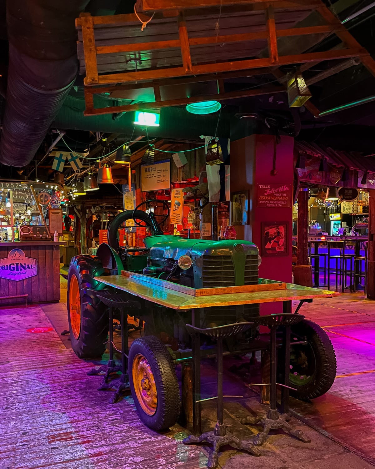 Tractor table and rustic farm decor inside Zetor restaurant and bar.