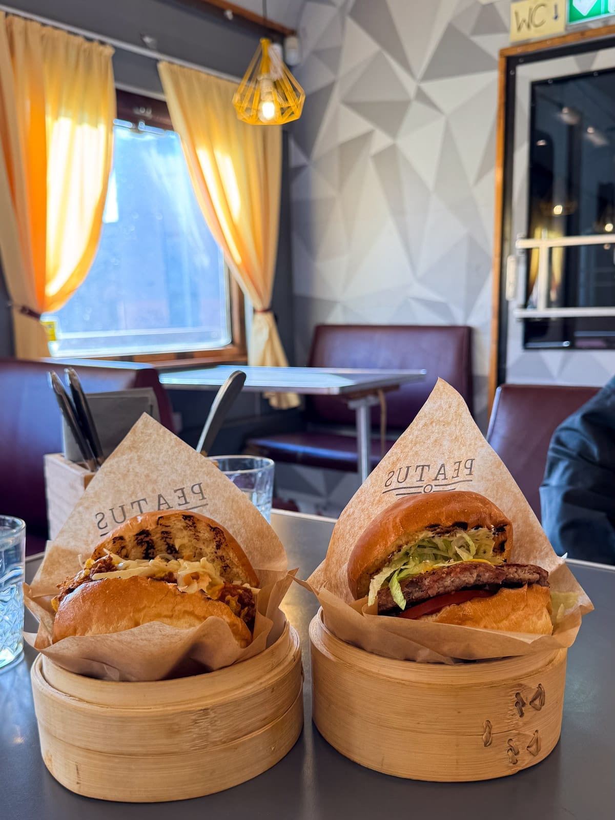 Two gourmet burgers served in bamboo steamers inside Peatus's Soviet-era wagon.