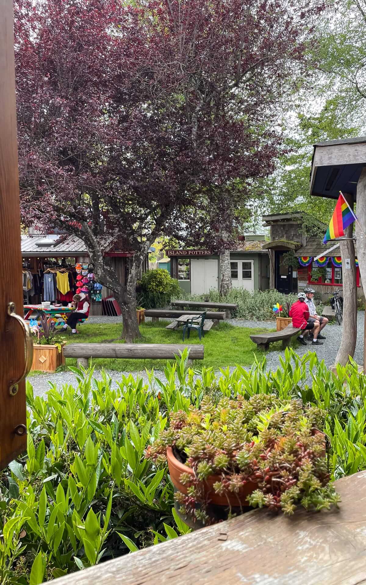 View across Ringside Market from Forage Restaurant with artisan shops, picnic tables, and local businesses.