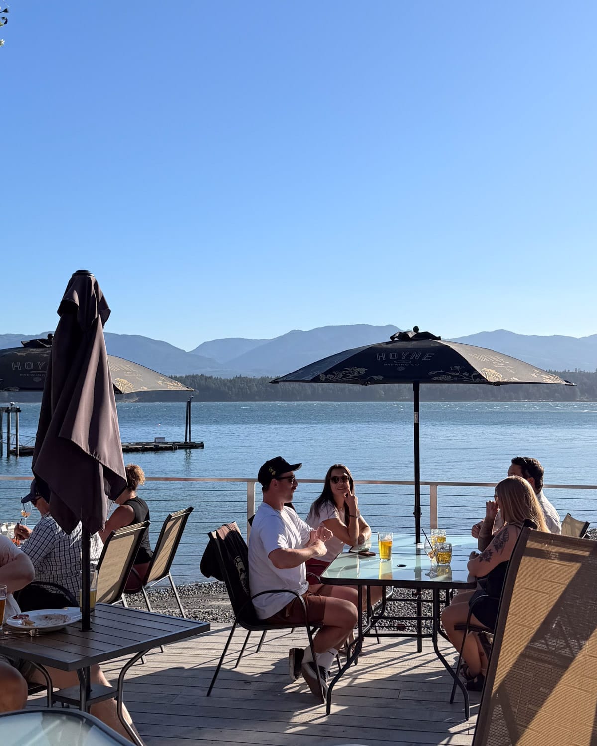 Patio dining with ocean views at Thatch Waterfront Pub overlooking Ford Cove Marina on Hornby Island.