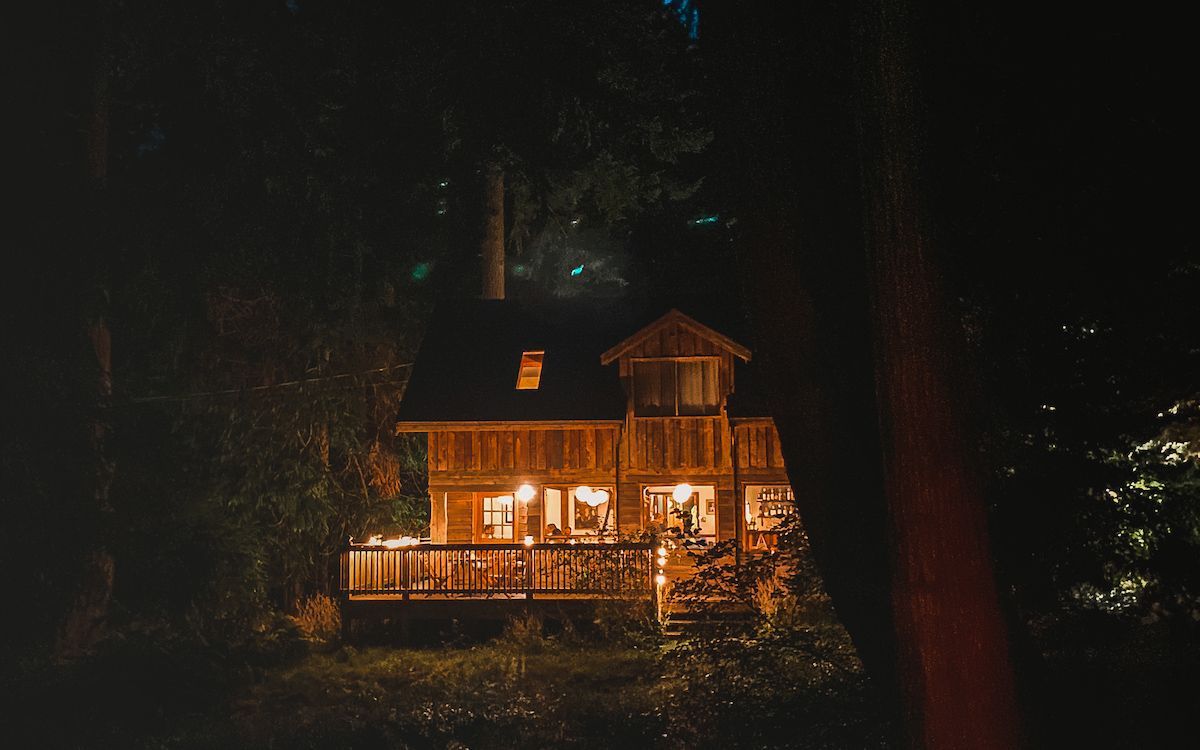 Pilgrimme, one of Galiano Island's top restaurants, glowing at night in the forest. 