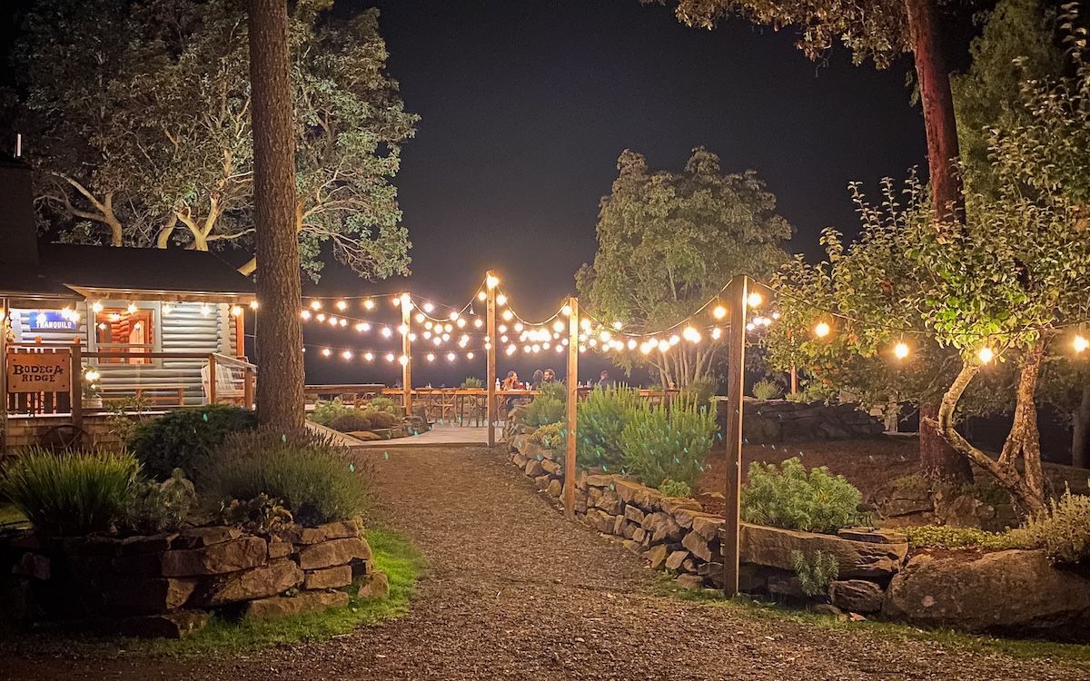 Bodega Ridge, one of Galiano Island's coziest places to stay, lit up by fairy lights at night.