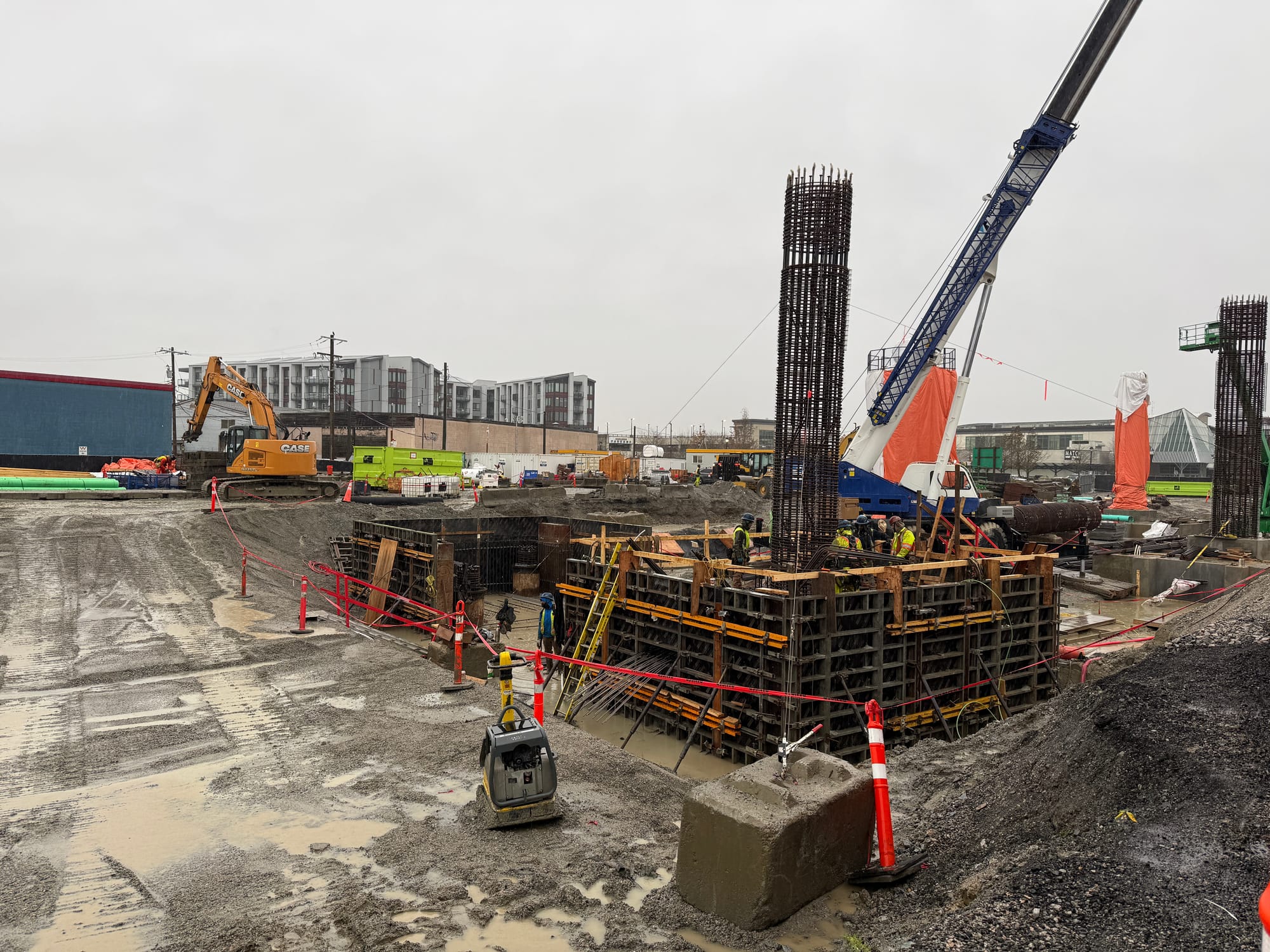 Ironworkers building columns to support the Langley City Centre SkyTrain Station