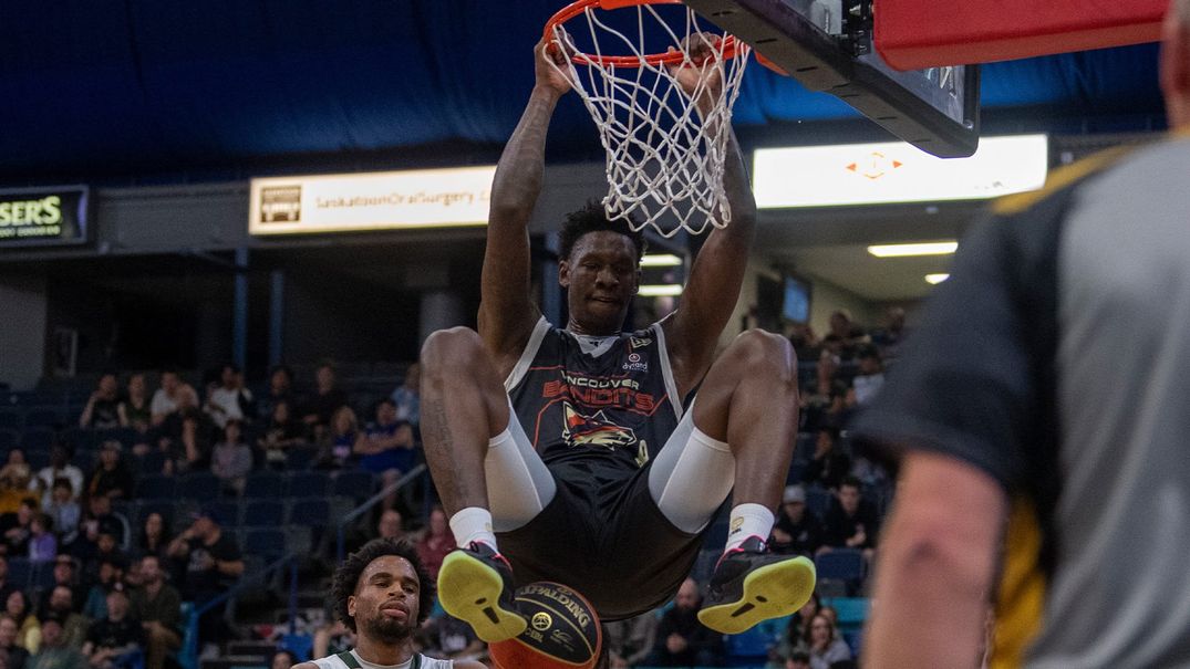 A photo of a Vancouver Bandits player dunking the basketball