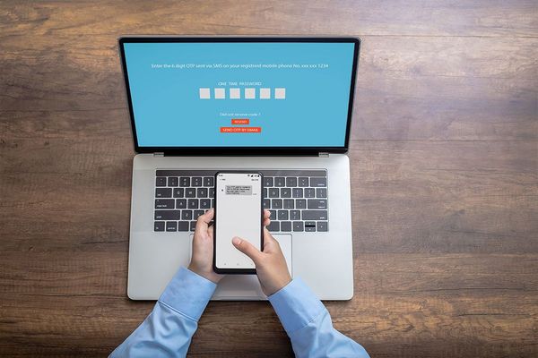Image of person using multi-factor authentication to log into their laptop with an SMS code.