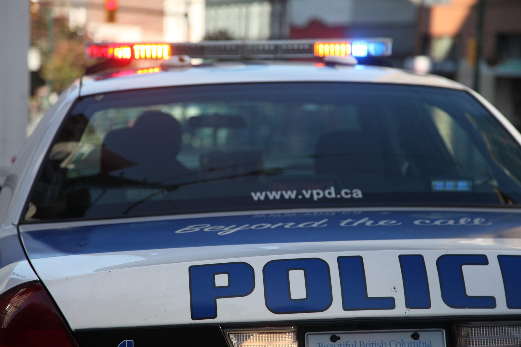 A Vancouver Police Department car has its sirens and light bar on.