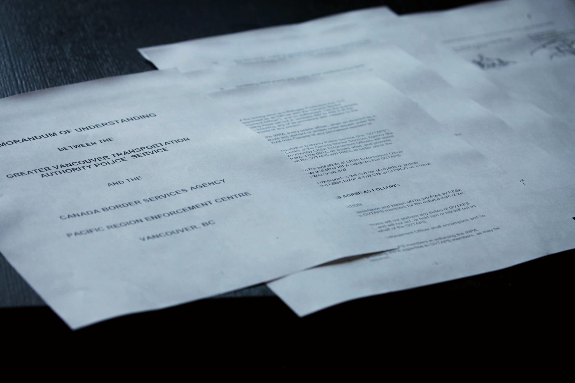 A pile of documents of a "Memorandum of Understanding" between Transit Police and Canada Border Services Agency
