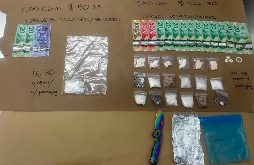 A similar image, cropped and angled differentl; the bills, baggies, and knife all looking noticeably different, and some coins now appear