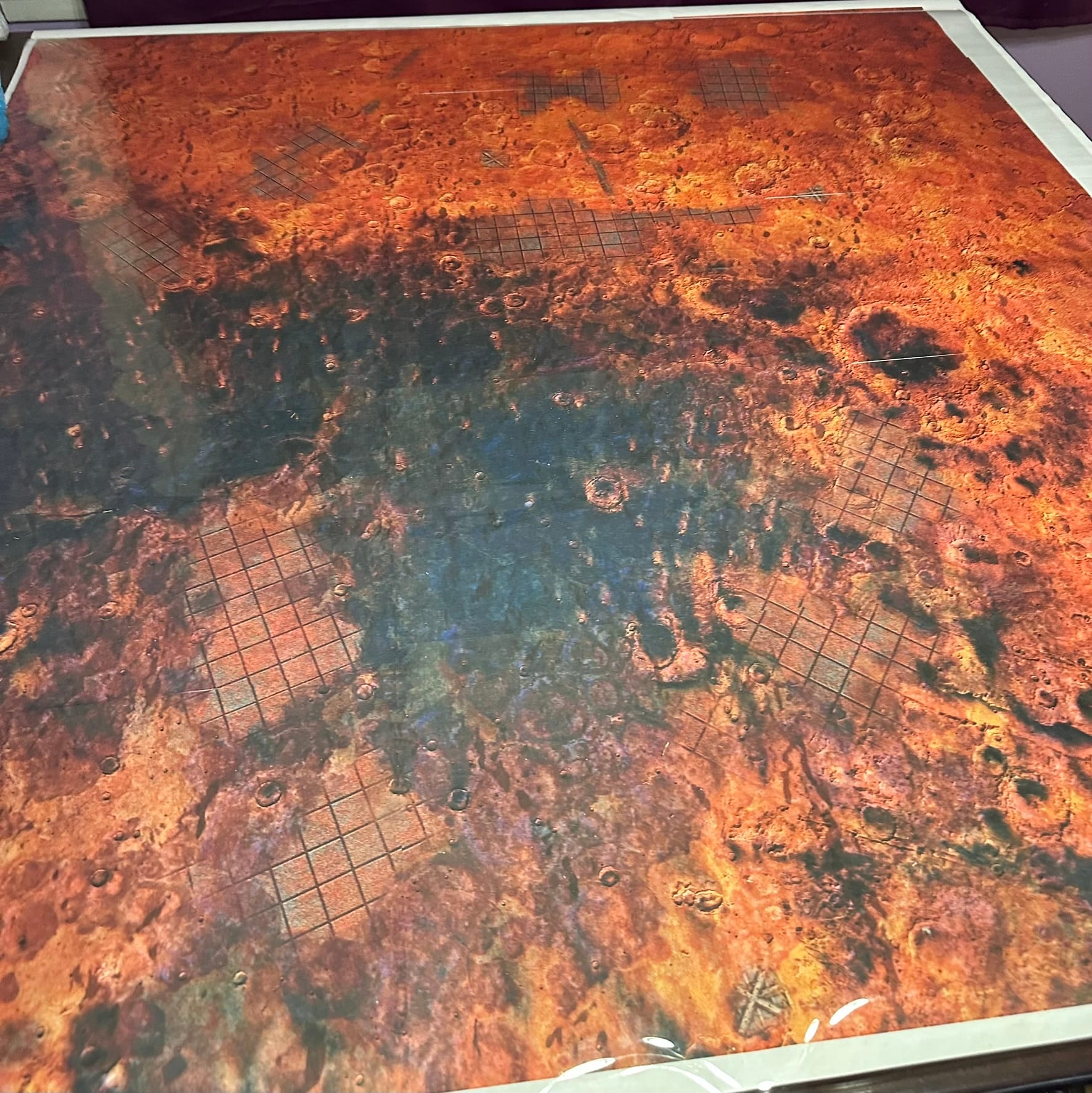 A large red desert battle mat for table-top wargaming. 