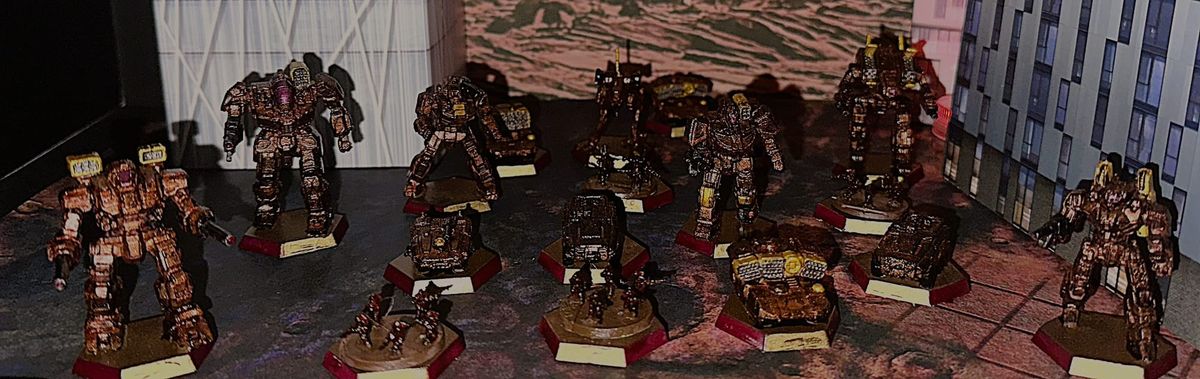 A variety of Battletech models in a red and gold livery. 