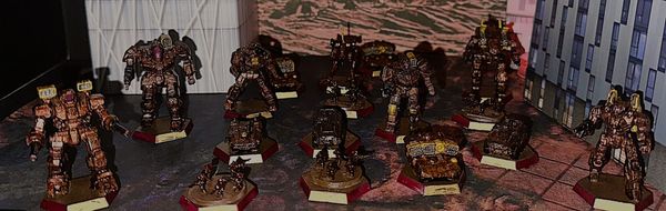 A variety of Battletech models in a red and gold livery. 