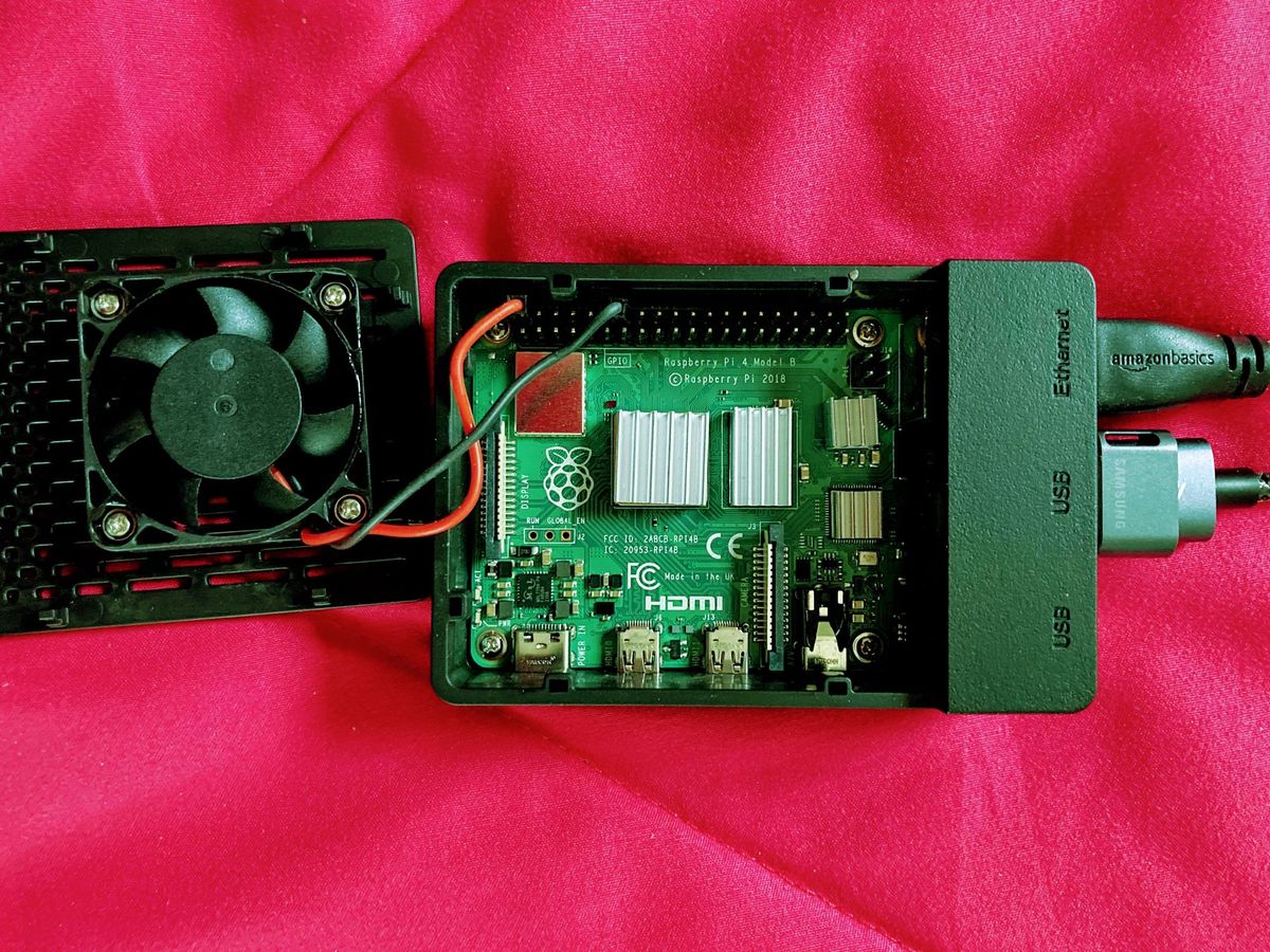 Raspberry Pi 4 in a fan-case, lid wide-open showing fan and wiring. 