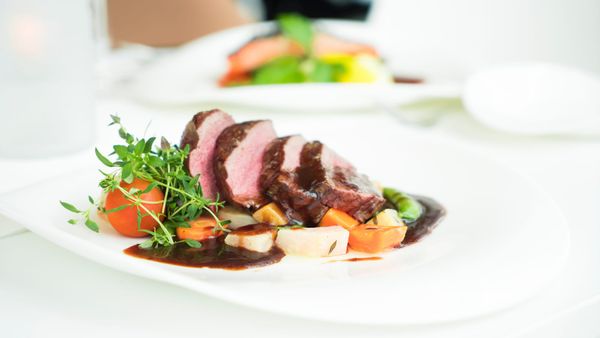 Plate of sliced beef with vegetables and garnish, showcasing a nutrient-dense, satiating meal