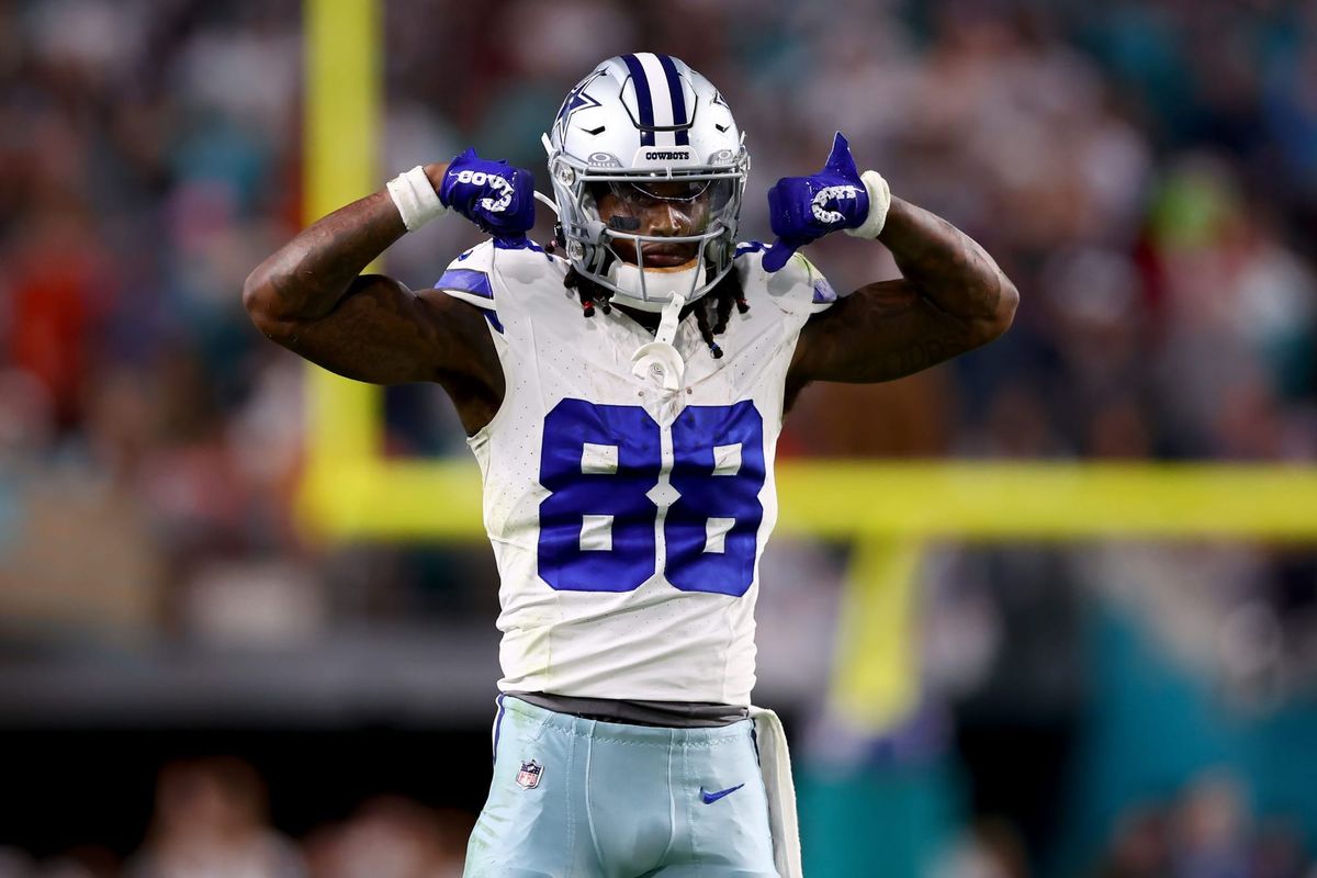 CeeDee Lamb celebrating a win on the field, in a Dallas Cowboys jersey and helmet