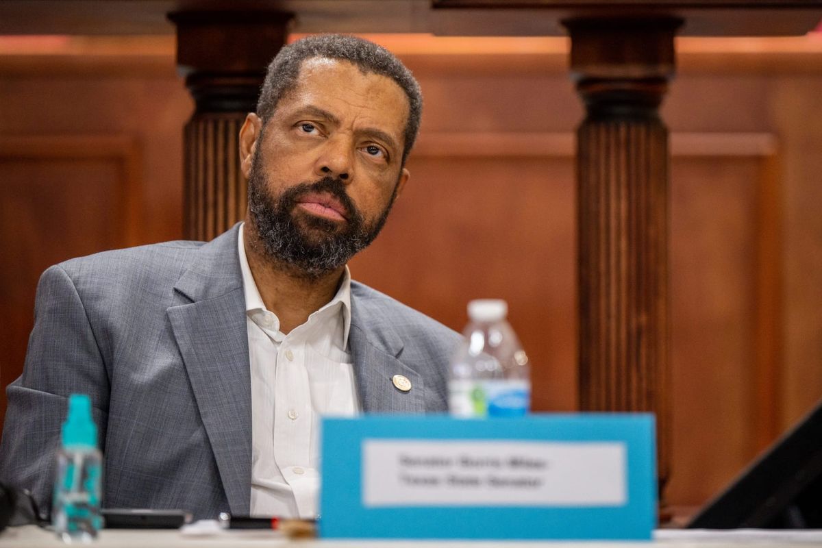 State Sen. Borris Miles sitting at a desk with a bottle of water