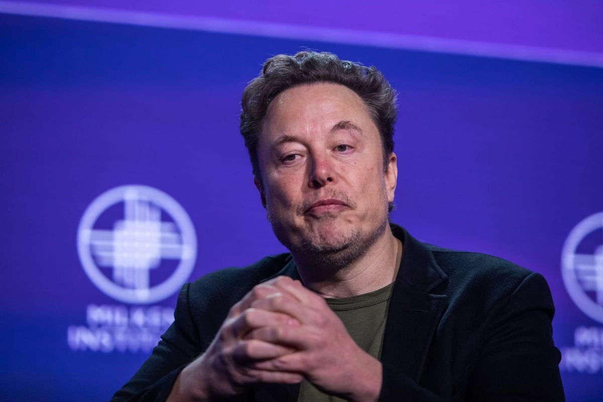 Elon Musk speaking on a stage