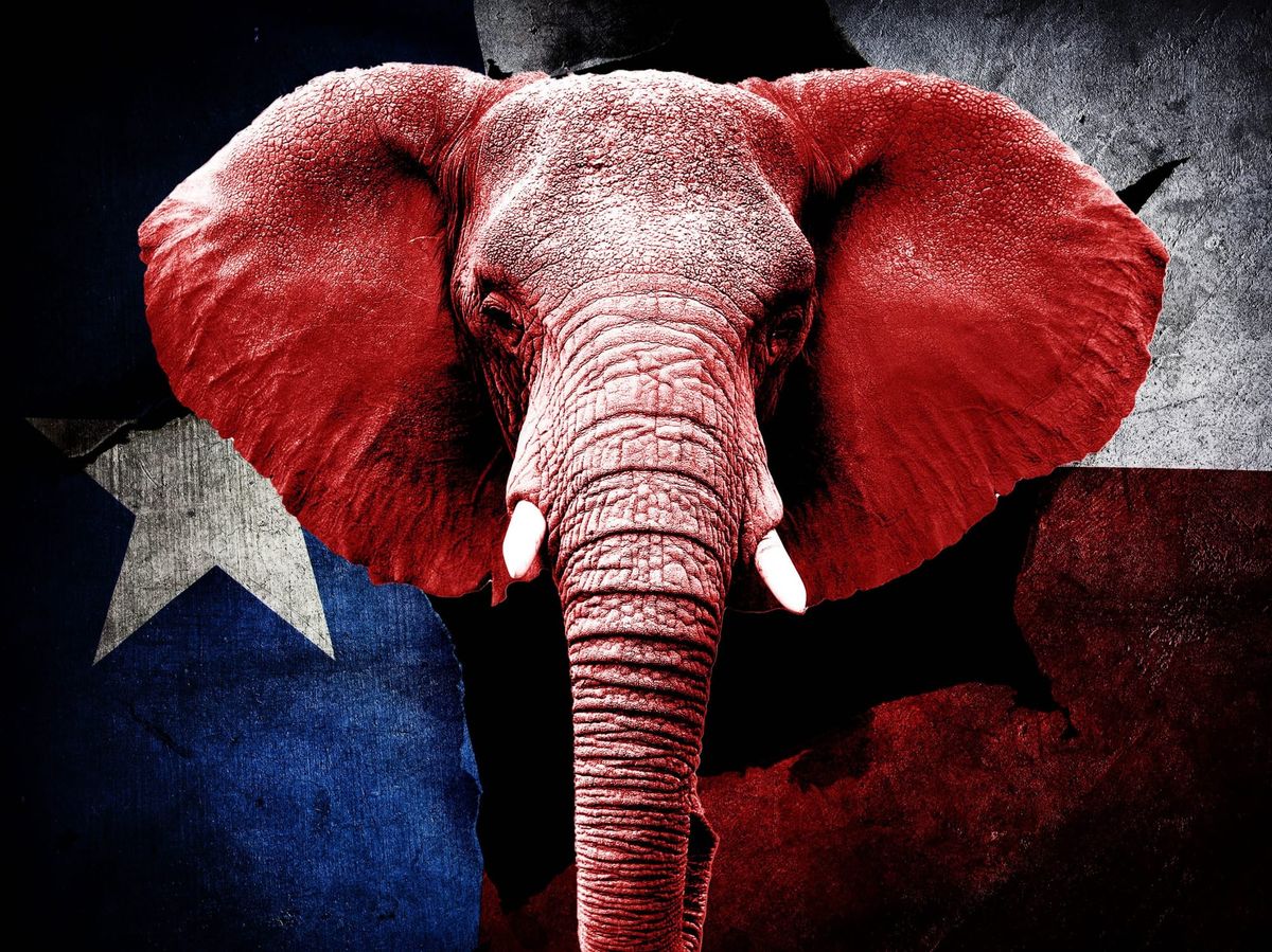 a red elephant walking in front of a Texas flag