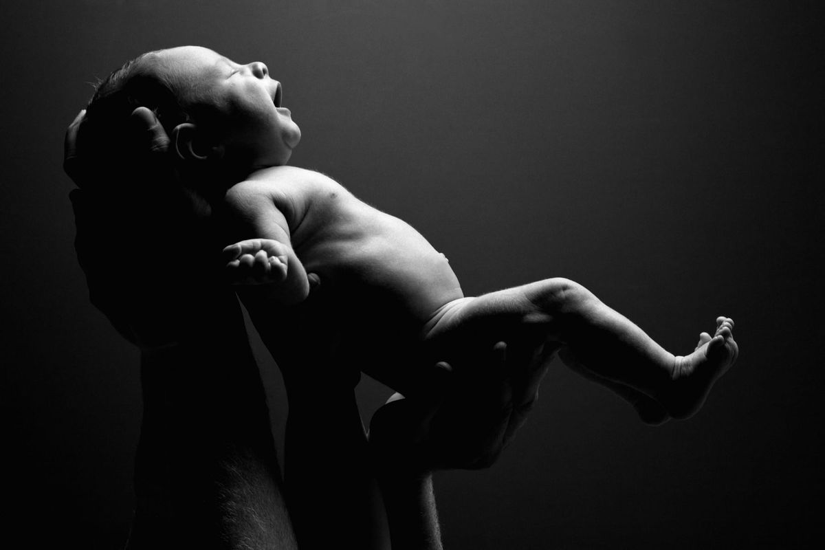 a baby being held up to the light