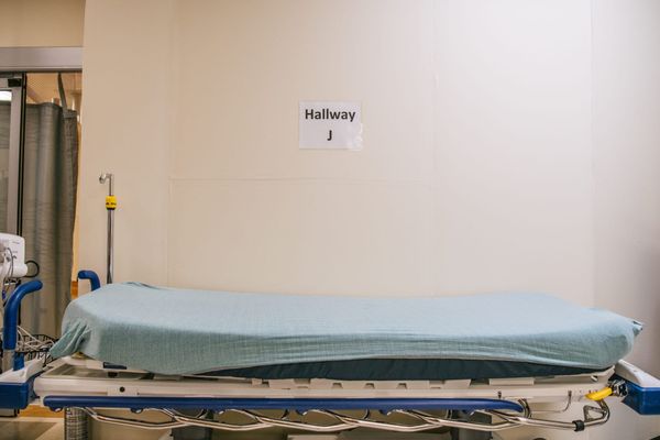 an empty hospital bed in a hallway