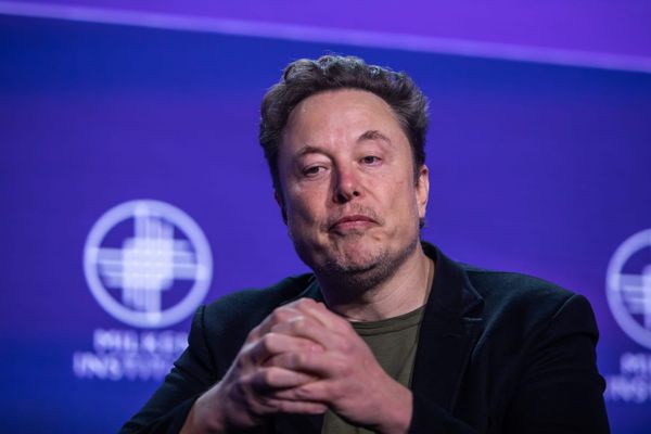 Elon Musk speaking on a stage