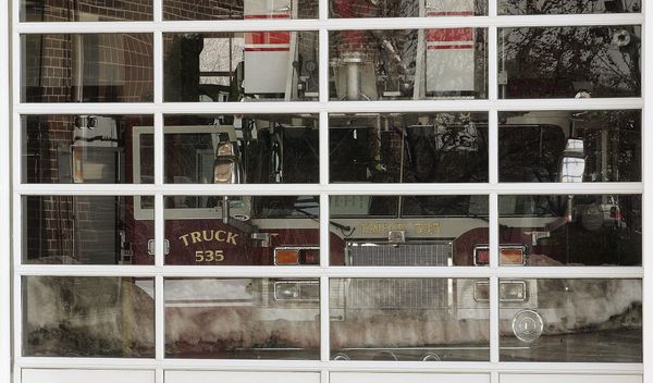 A firetruck seen through glass windows