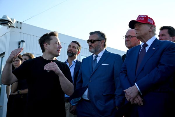 elon musk, senator ted cruz, and donald trump looking forward and talking to one another against a cloudless blue sky