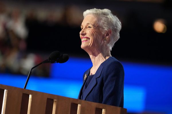 Cecile Richards smiling at the dais during a speech at the DNC, with a blue background