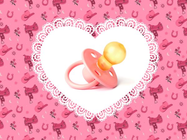 a pacifier inside a white heart, with pink cowboy themed images in the background
