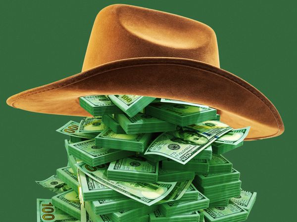 a cowboy hat on a stack of money