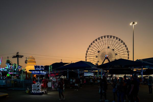 People enjoy amusement park attractions at the State Fair of Texas on Sept. 26, 2025 in Dallas. (Photo by Brandon Bell/Getty 